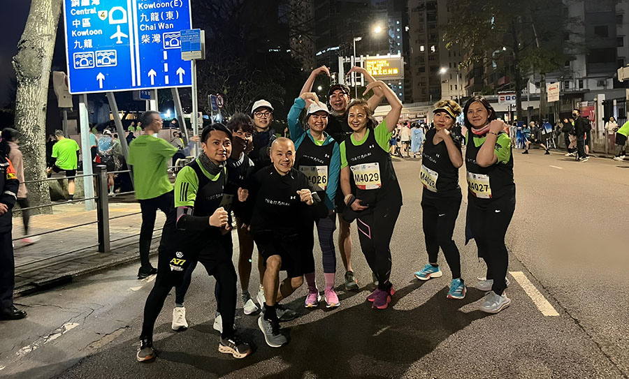 Terminal 8 team members posing for a group photo at the marathon start zone in the early morning. Terminal 8 team members posing for a group photo at the marathon start zone in the early morning.